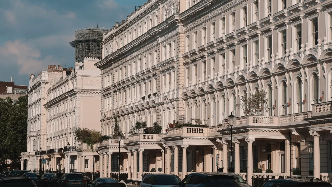 A row of freshly painted white stucco terraces in central London
