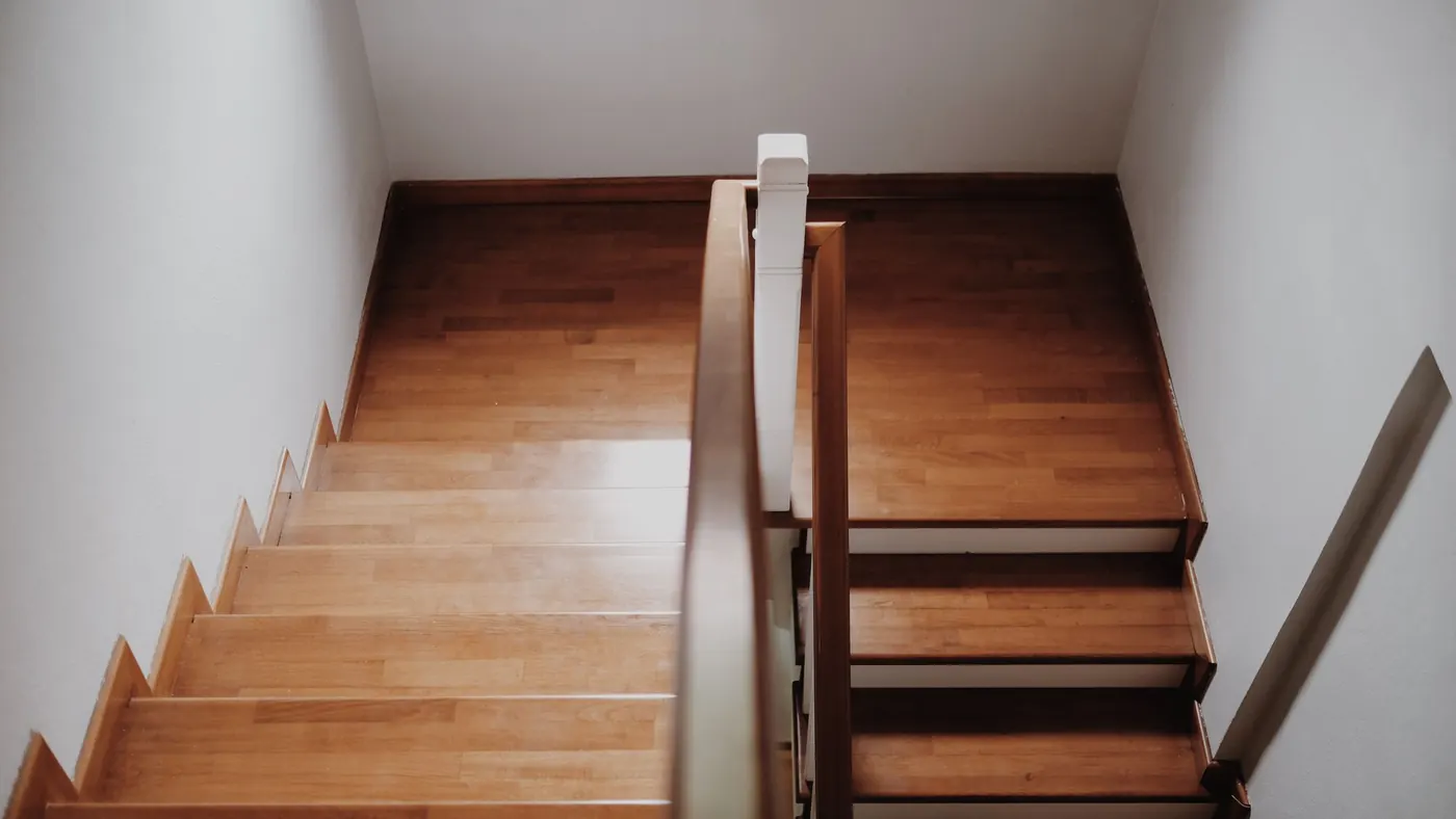 Looking down a polished timber staircase from the landing