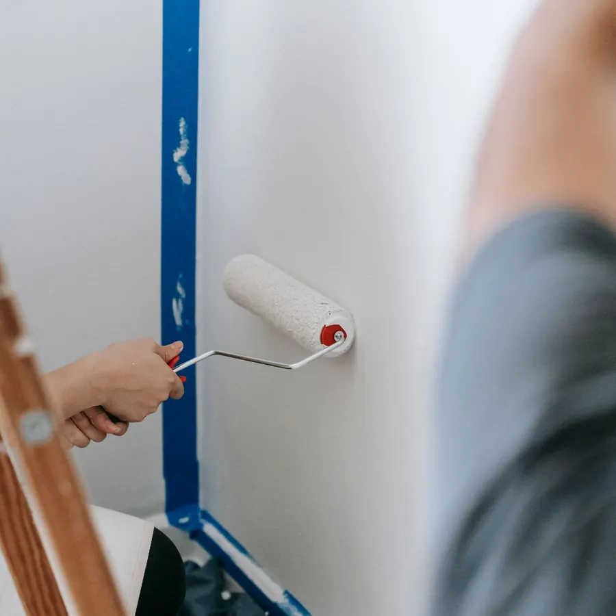Cutting in a wall edge with a mini roller against masked trim