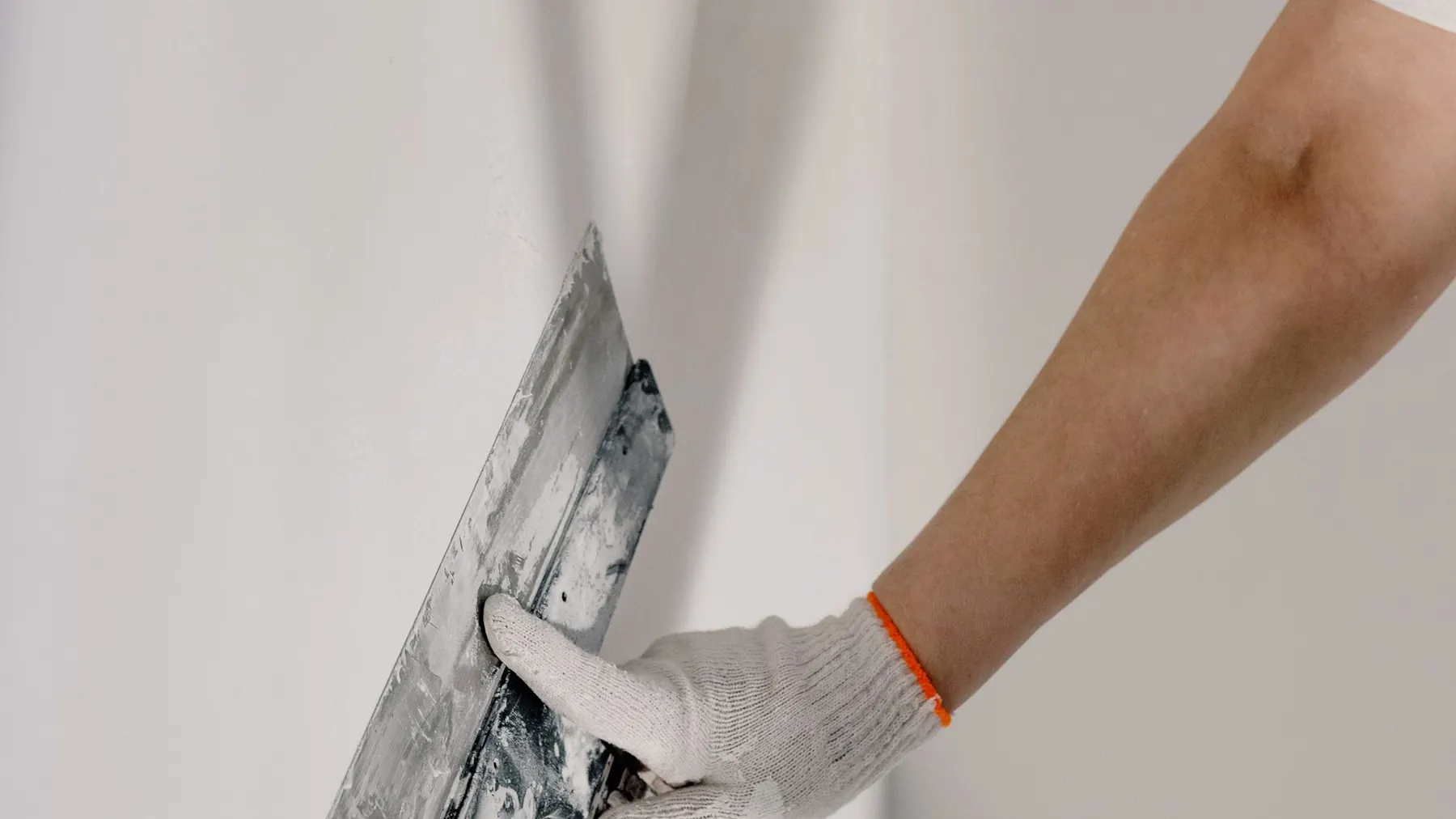 Trowel finishing a skim coat on an internal wall