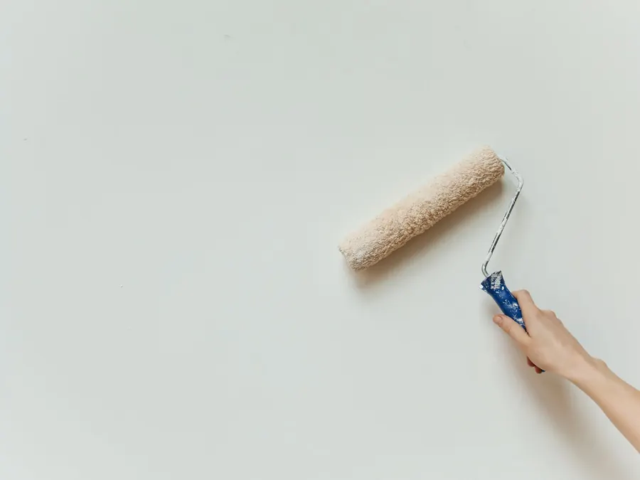 Rolling the first coat onto a prepared wall